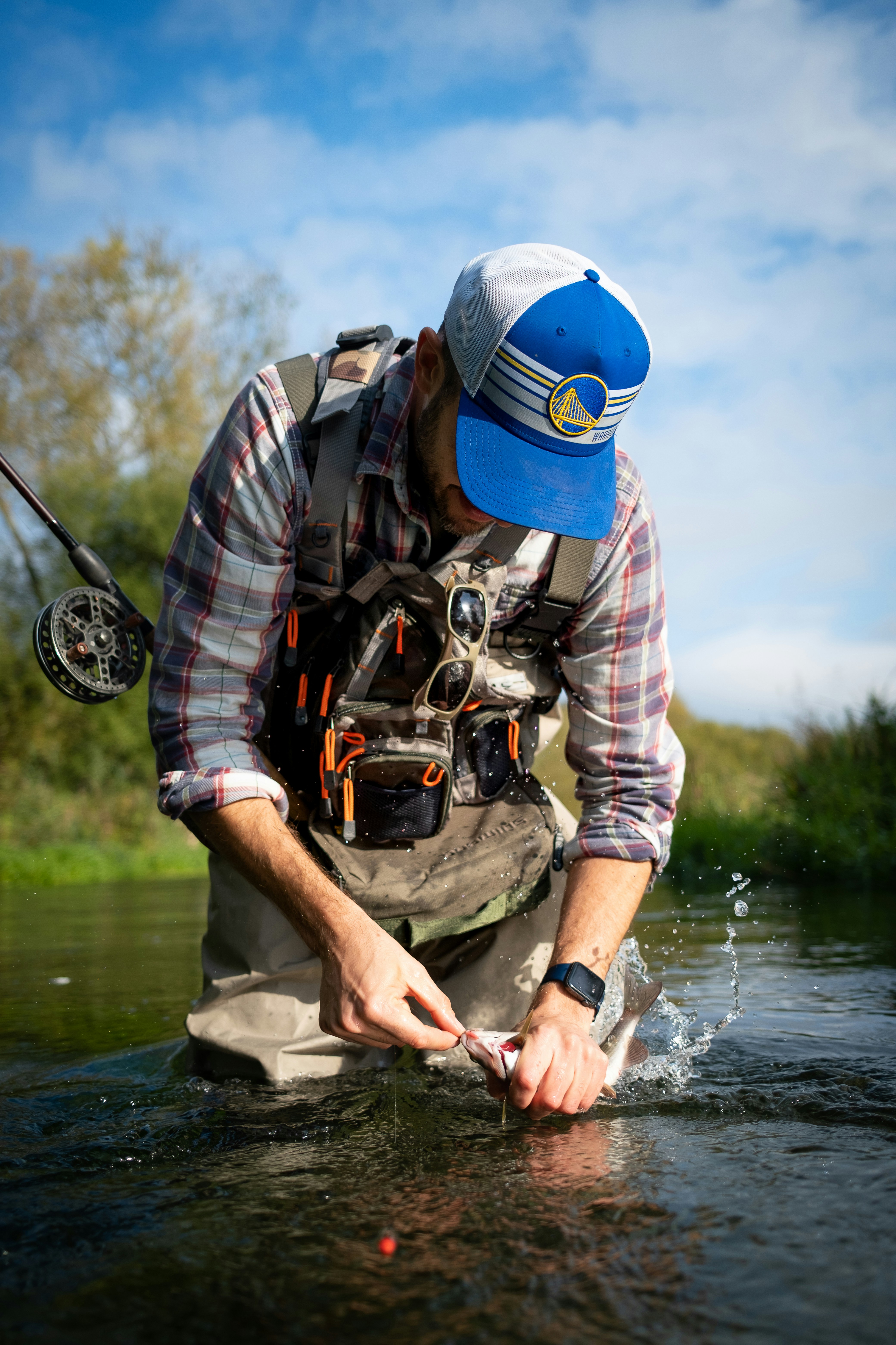 Fly reel with on a rock in the river